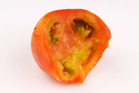 Bitten tomato on a white backgroundの写真素材