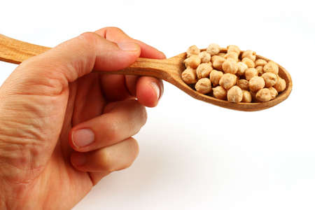 chickpeas in a spoon on a white background closeupの写真素材