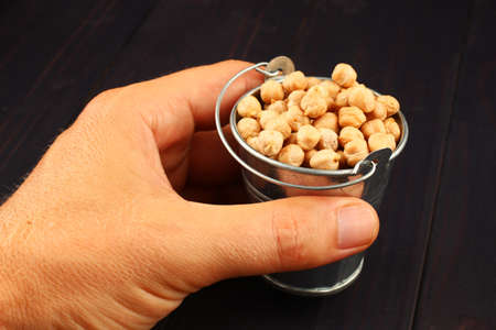 chickpeas in bucket on dark backgroundの写真素材