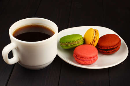 Coffee and Macaron on black backgroundの写真素材
