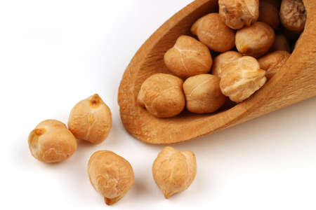 chickpeas in a scoop on a white background closeupの写真素材
