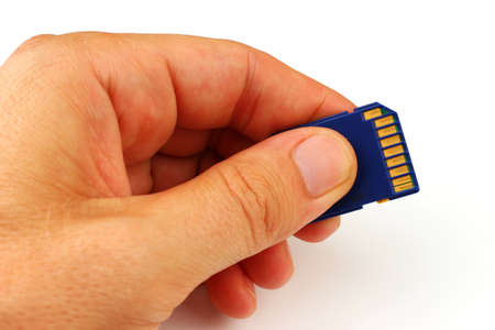 SD card in hand on a white background