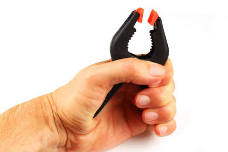 Black clothespin in hand on a white backgroundの写真素材