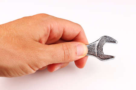 Wrench in hands on a white background closeup