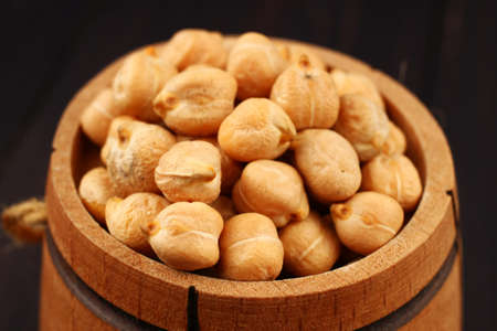 chickpeas peas in a barrel on a wooden background close upの写真素材