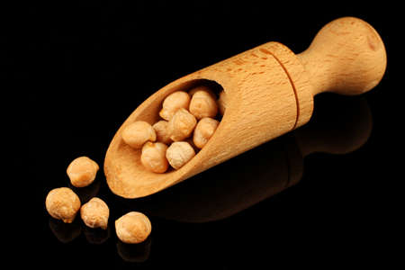 chickpeas peas in scoop on black backgroundの写真素材