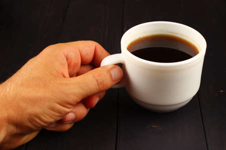 cup of coffee and hand holdsの写真素材