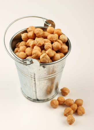 chickpeas peas in a bucket on a white backgroundの写真素材