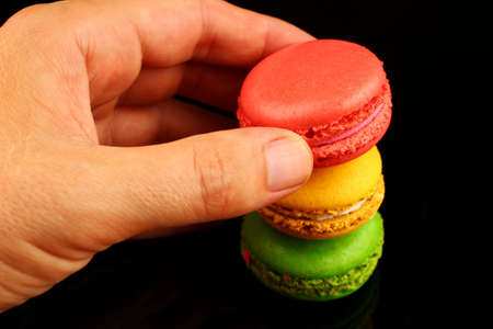 Macaroon colored cookies pastry in handの写真素材