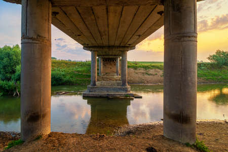Old concrete bridge across the riverの写真素材