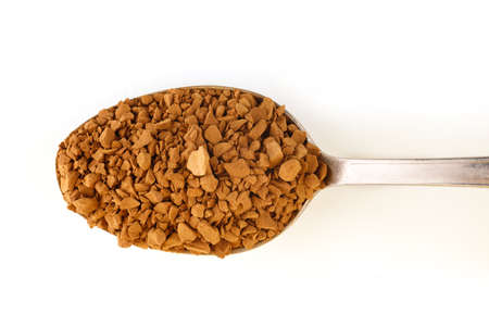 Instant coffee granules in a spoon isolate.の写真素材