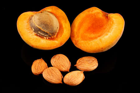 The apricot kernels on a black background
