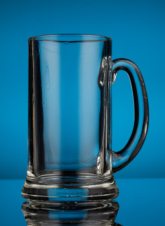 Empty glass beer glass on a blue backgroundの写真素材