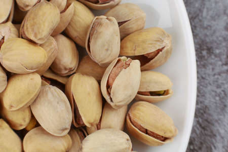 Pistachios are delicious nuts on a plateの写真素材