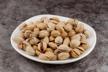 Pistachios are delicious nuts on a plateの写真素材