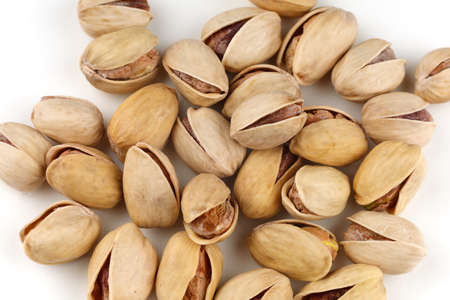 Delicious pistachios nuts on a white backgroundの写真素材