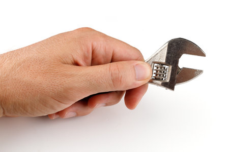 Metal adjustable wrench in hand isolateの写真素材
