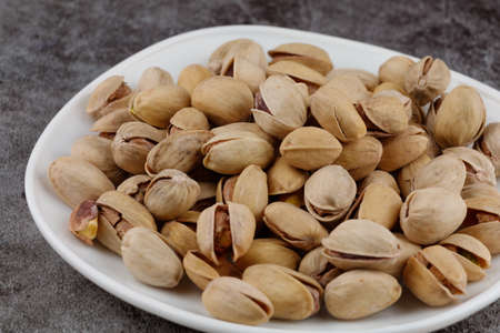 Pistachios are delicious nuts on a plateの写真素材