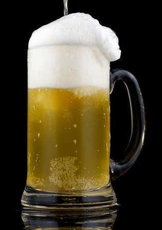 Beer in a glass and white foamの写真素材