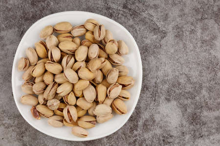 Pistachios are delicious nuts on a plateの写真素材