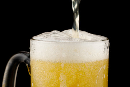 Beer in a glass and white foamの写真素材