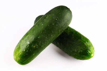 Green cucumbers on a white backgroundの写真素材