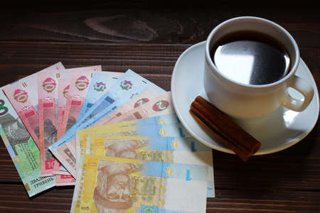 Ukrainian hryvnia money and a cup of coffee