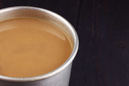 Coffee with milk in the old cup close-up