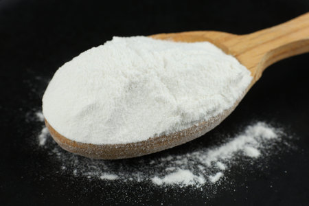 Protein powder in a wooden spoon