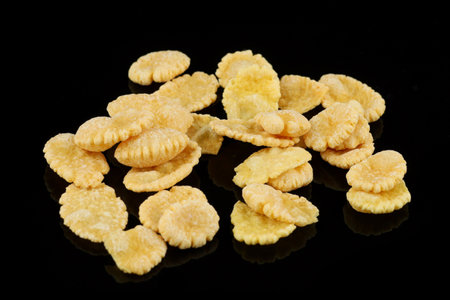 A few corn flakes on a black backgroundの写真素材
