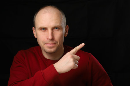 Man pointing with finger to space for textの写真素材