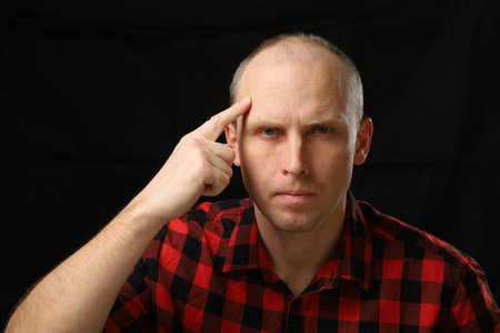 Caucasian man pointing finger at brainの写真素材