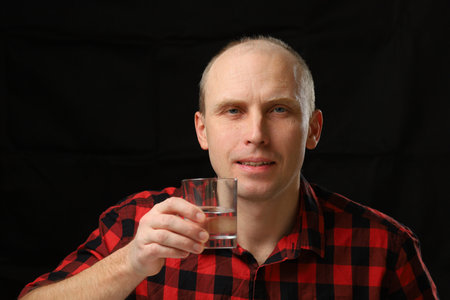 Caucasian man holding a glass of waterの写真素材