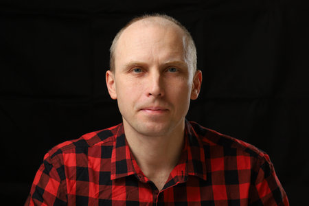 Portrait of a handsome middle-aged man in a checkered shirtの写真素材