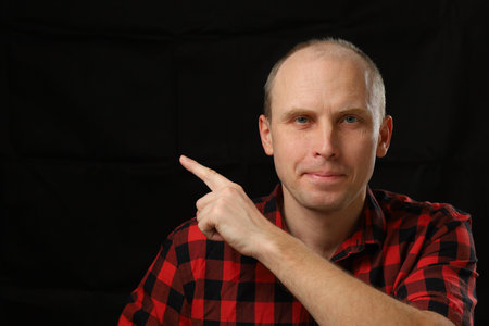 Caucasian man pointing finger at empty spaceの写真素材