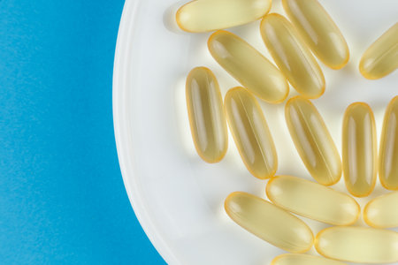 Omega 3 gelatin capsules on a white plateの写真素材