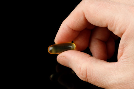 Omega 3 gelatin capsules in handの写真素材