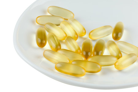 Omega 3 gelatin capsules on a white plateの写真素材
