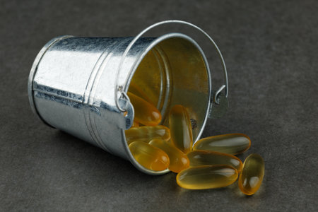 Omega 3 gelatin capsules in a metal bucketの写真素材