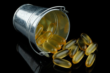 Omega 3 gelatin capsules in a metal bucketの写真素材