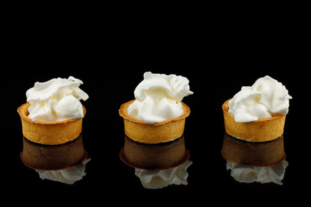 Baskets with cream on a black background. A simple dessert.の写真素材