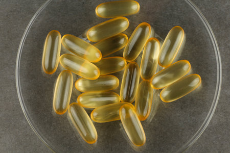 Omega 3 gelatin capsules close-up on a glass plateの写真素材