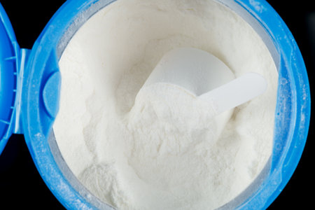 A jar with protein and a scoopの写真素材