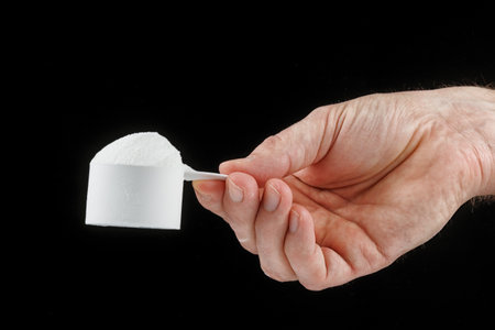 Scoop with protein in handの写真素材
