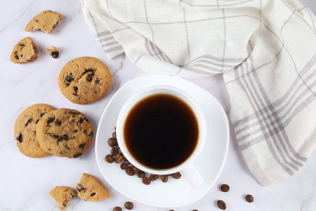 White cup of coffee and chocolate cookie