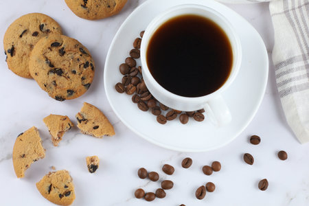 White cup of coffee and chocolate cookieの写真素材
