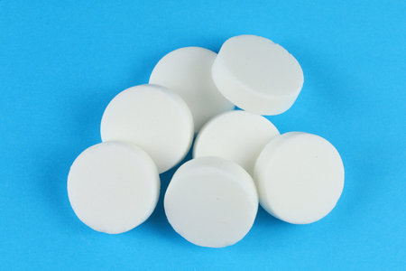 Hexamine fuel tablet on a blue background.の写真素材