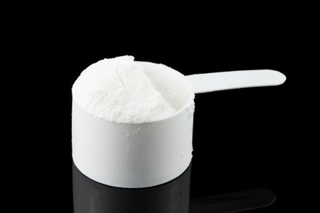 Gainer in a spoon. Sports nutrition and a measuring spoonの写真素材