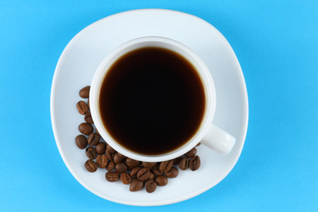 Coffee in a white cup and coffee beansの写真素材