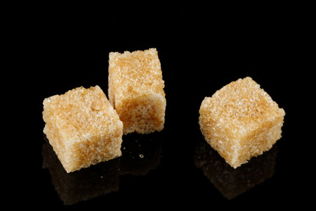 Three pieces of brown sugar isolate. cane sugar.の写真素材